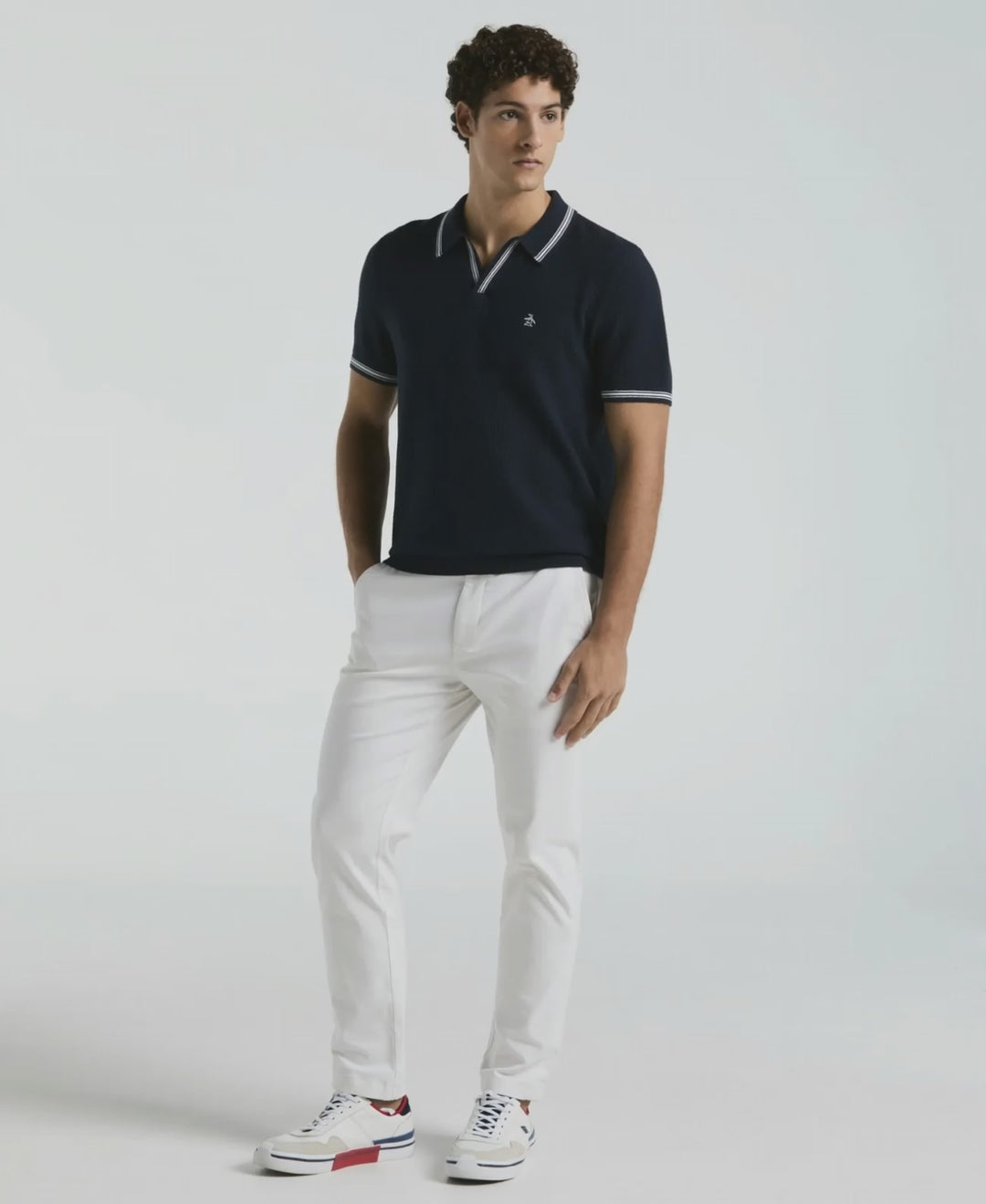 Video of a man wearing the Original Penguin Textured Johnny Collar Sweater Polo in the color Dark Sapphire